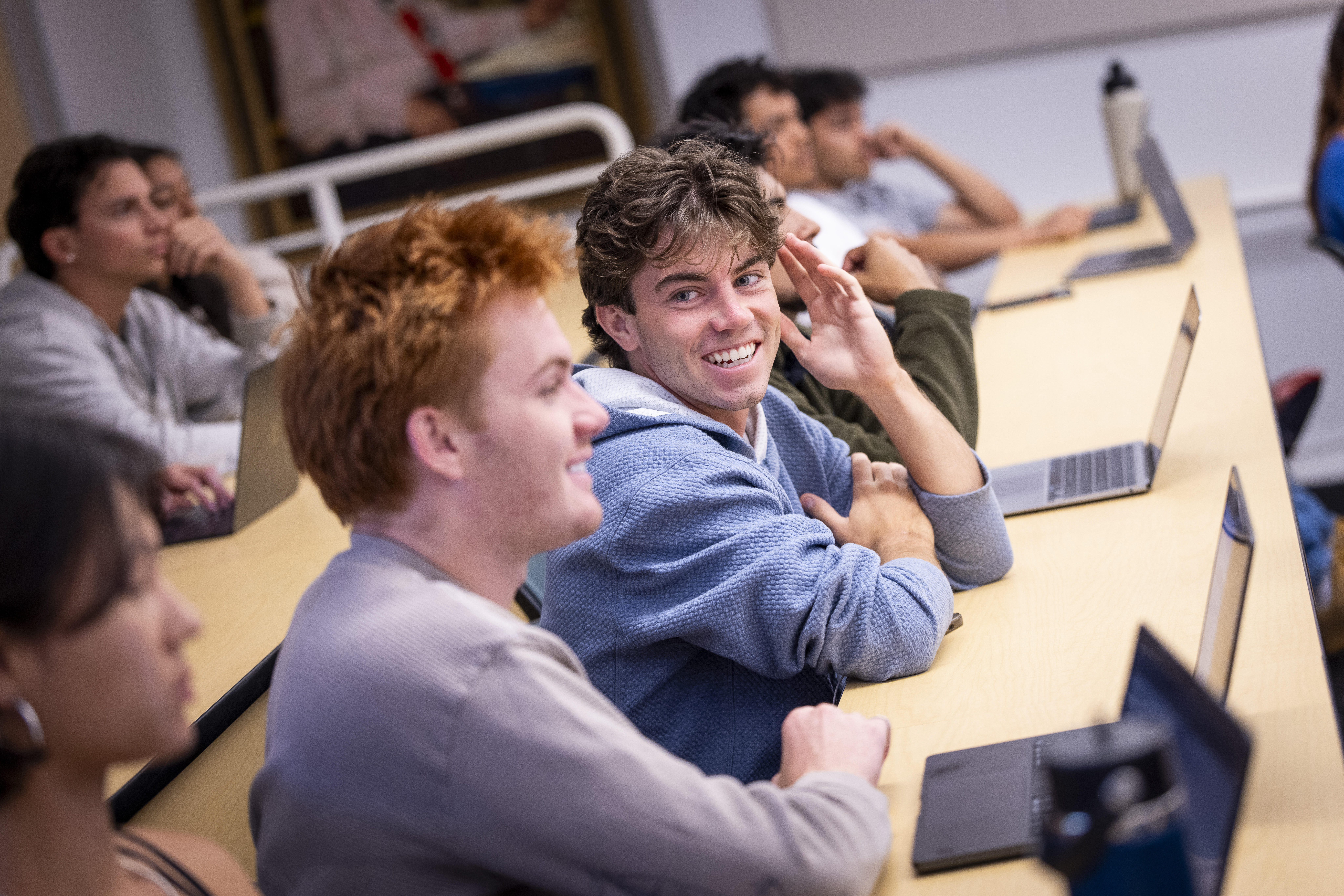 male westmont students talking in class
