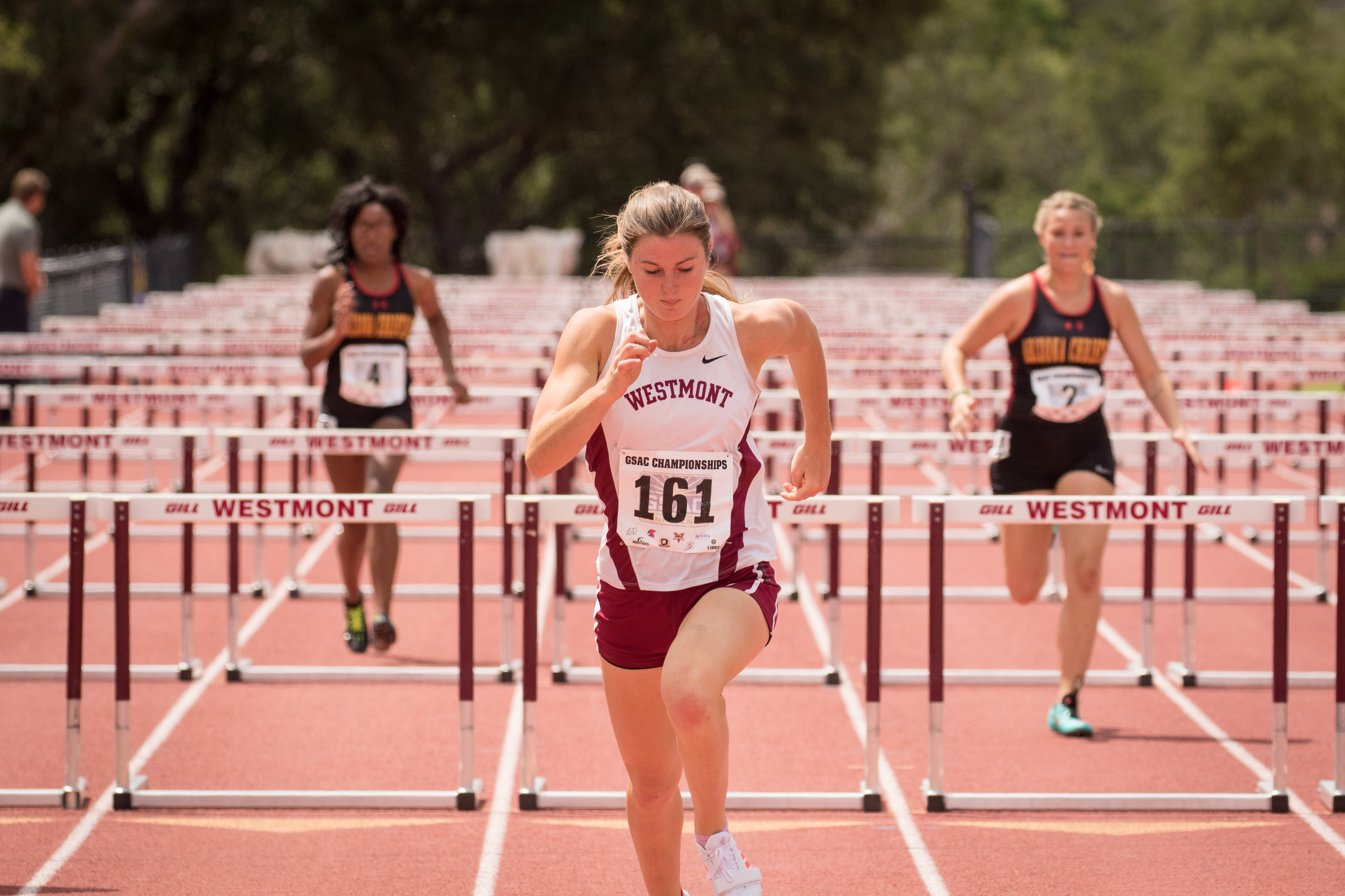 Student in the lead in a hurdle track race