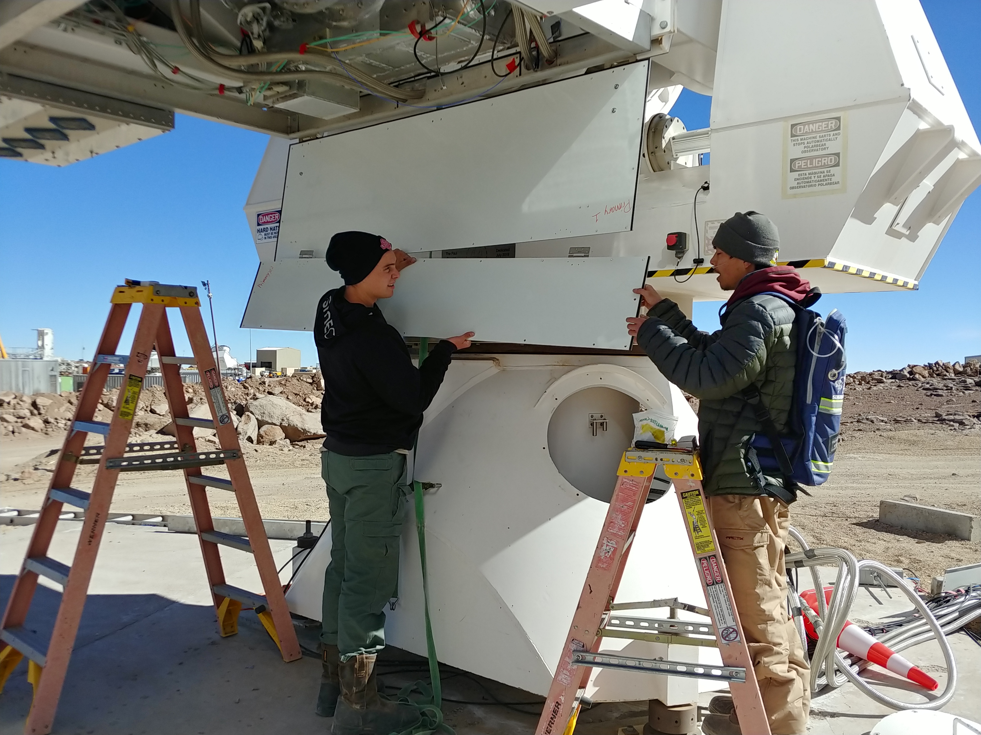 Westmont students Jacob Nelson and Michael Lew work on a telescope at the Simons Array in Chile