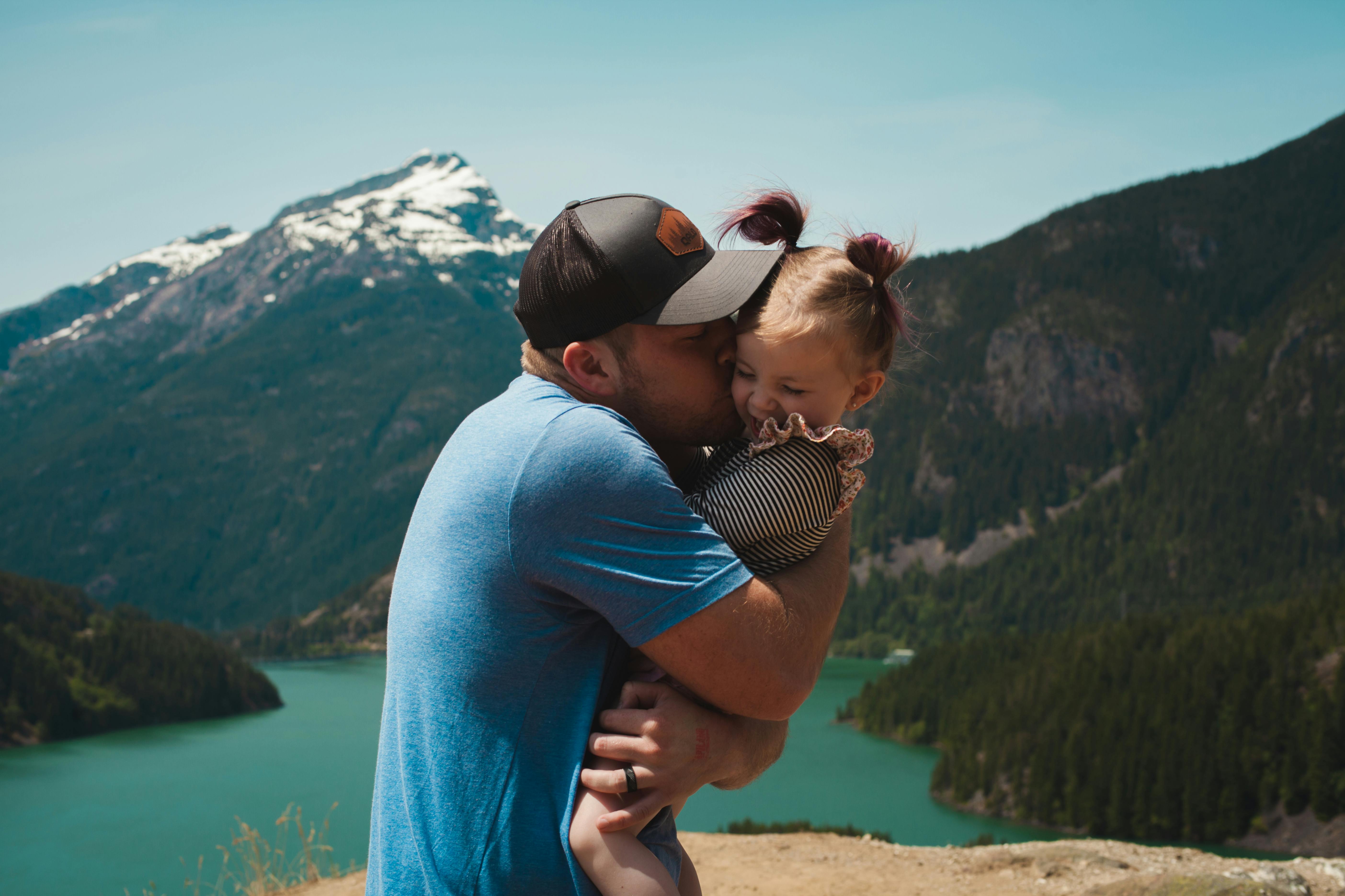 father caressing young daughter