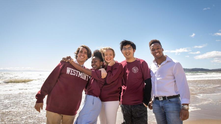 international westmont students hugging on beach